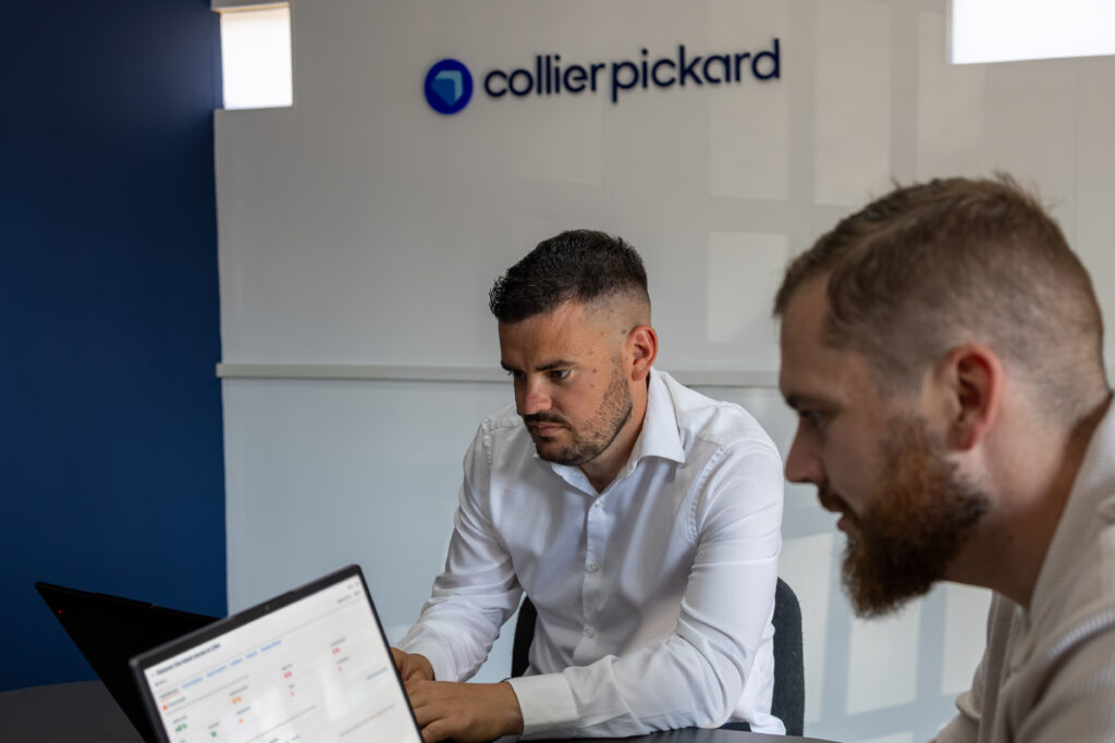 Laurie Probert and Ollie Bartlett infront of Collier pickard Sign